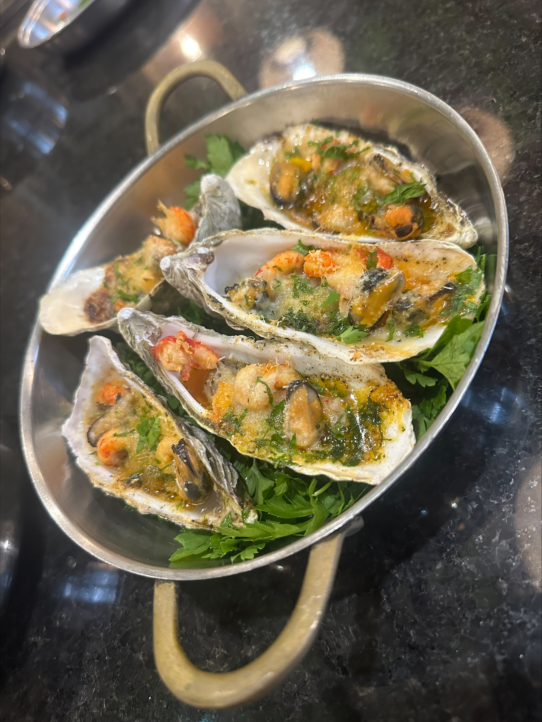 Baked oysters with crayfish tails and garlic butter