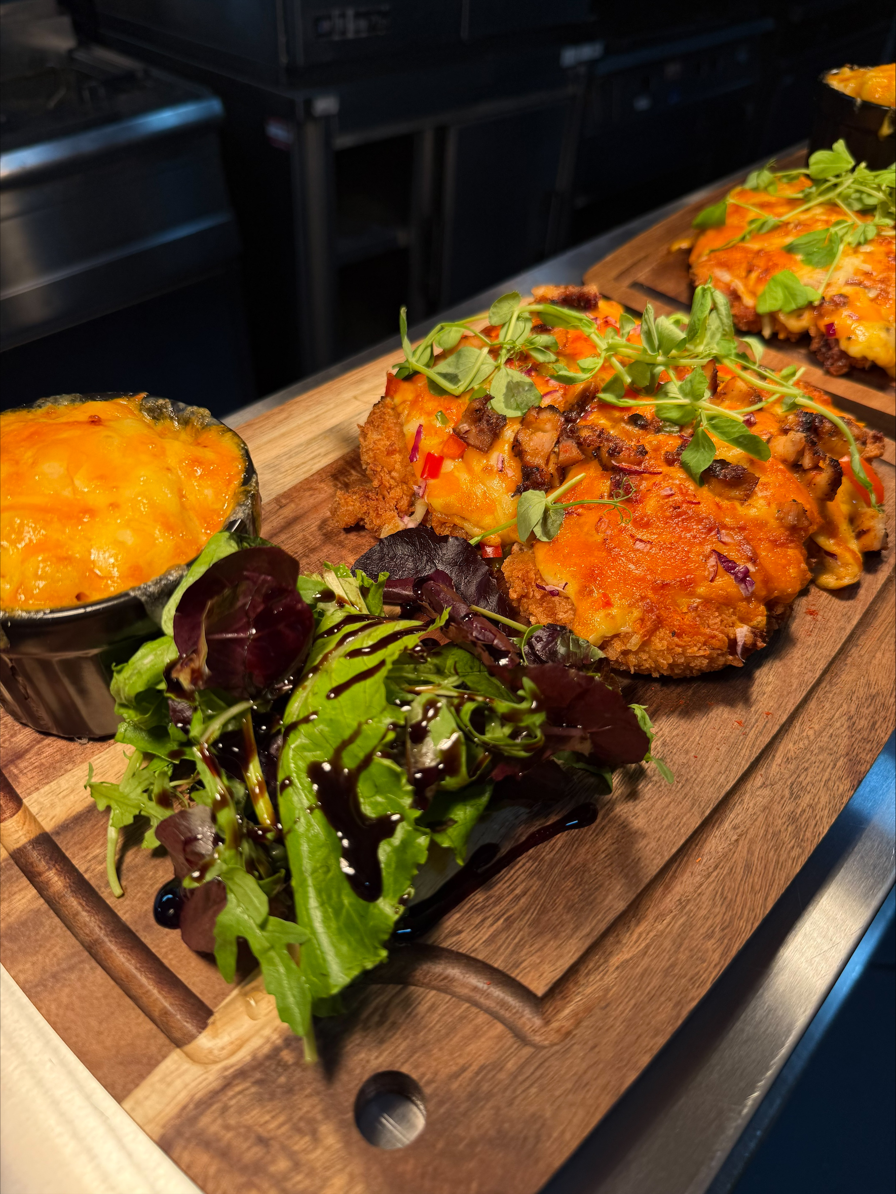 Parmo board with multiple golden crispy parmos and mac cheese