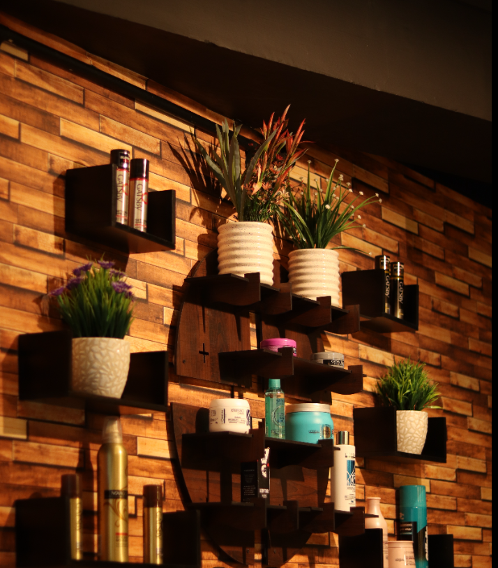 Premium hair-care products on a wooden display wall at Kaizen