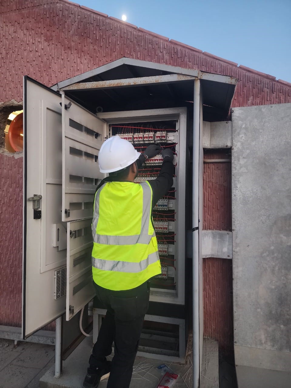 Technician working on electrical panel