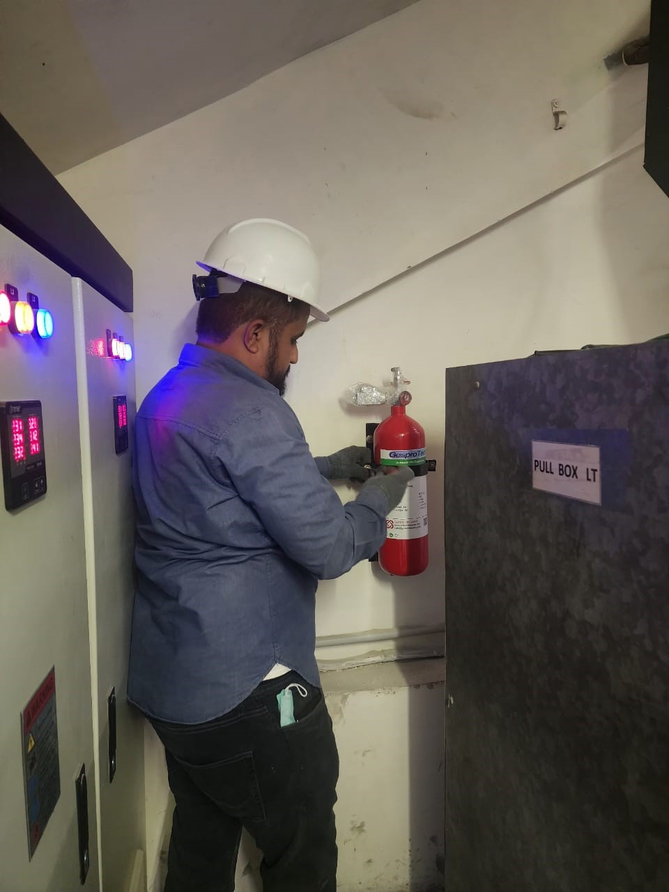 Worker installing fire suppression system