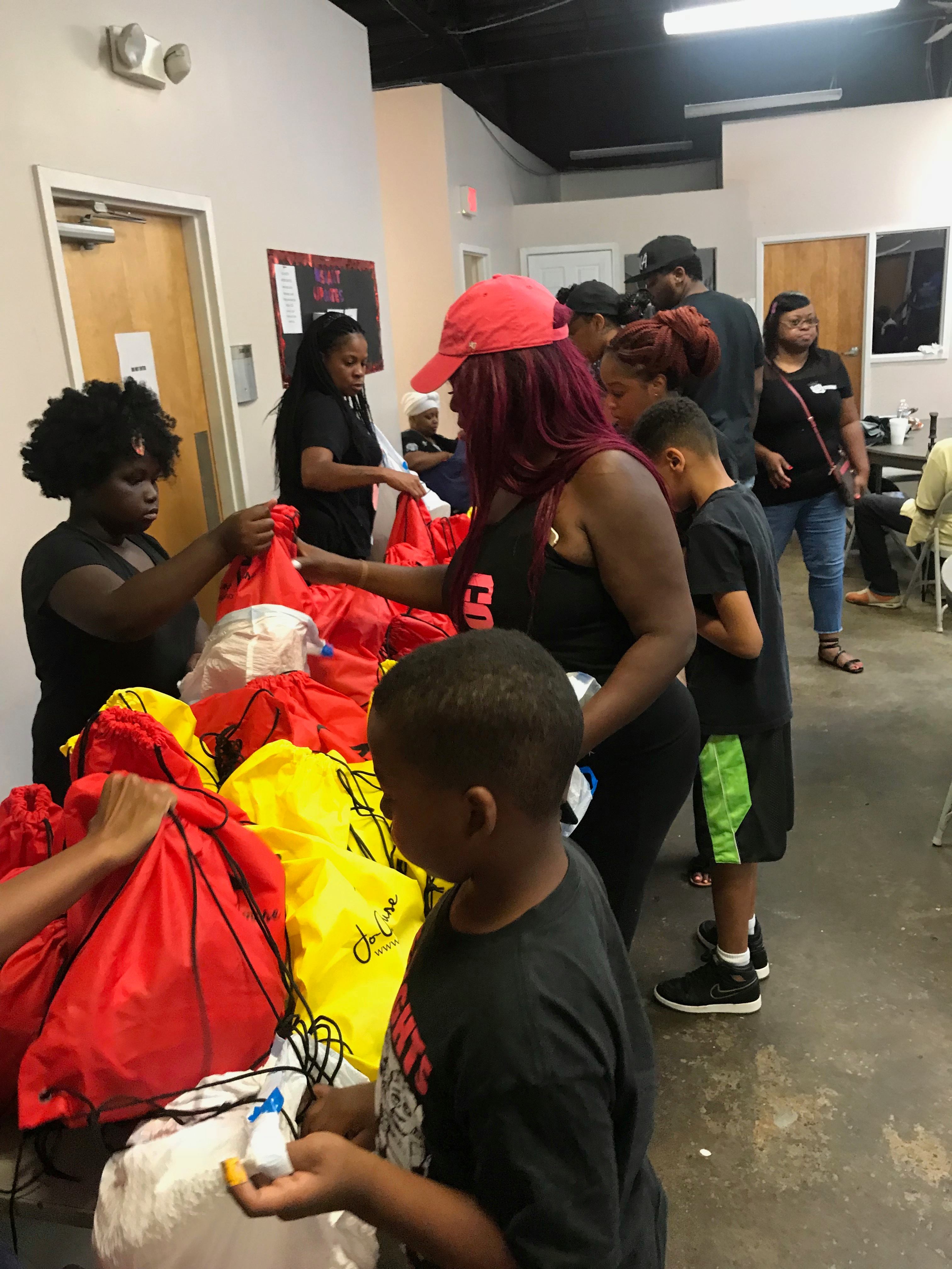 Volunteers packing donation bags indoors