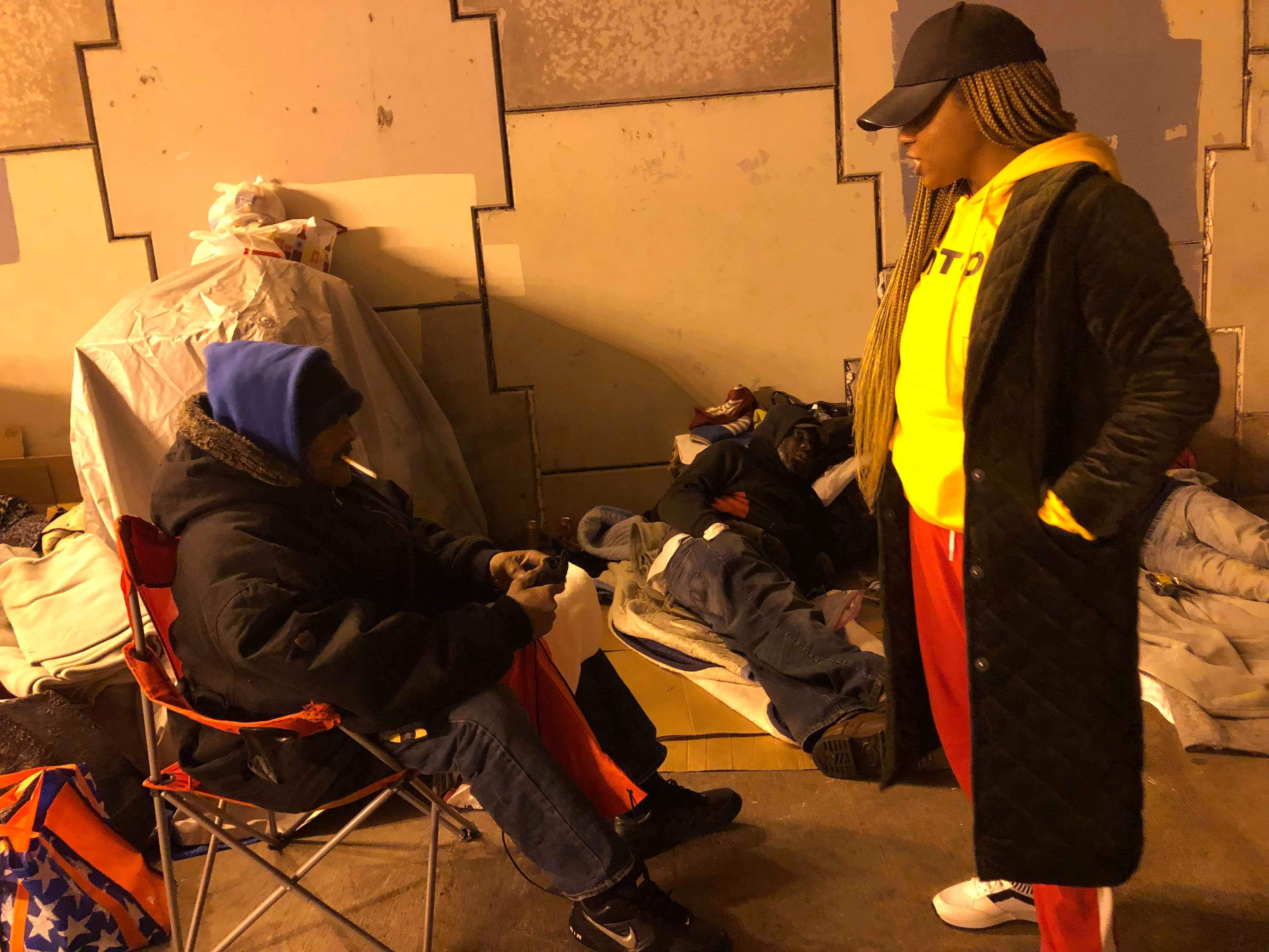 Volunteer speaking with community member at night outreach