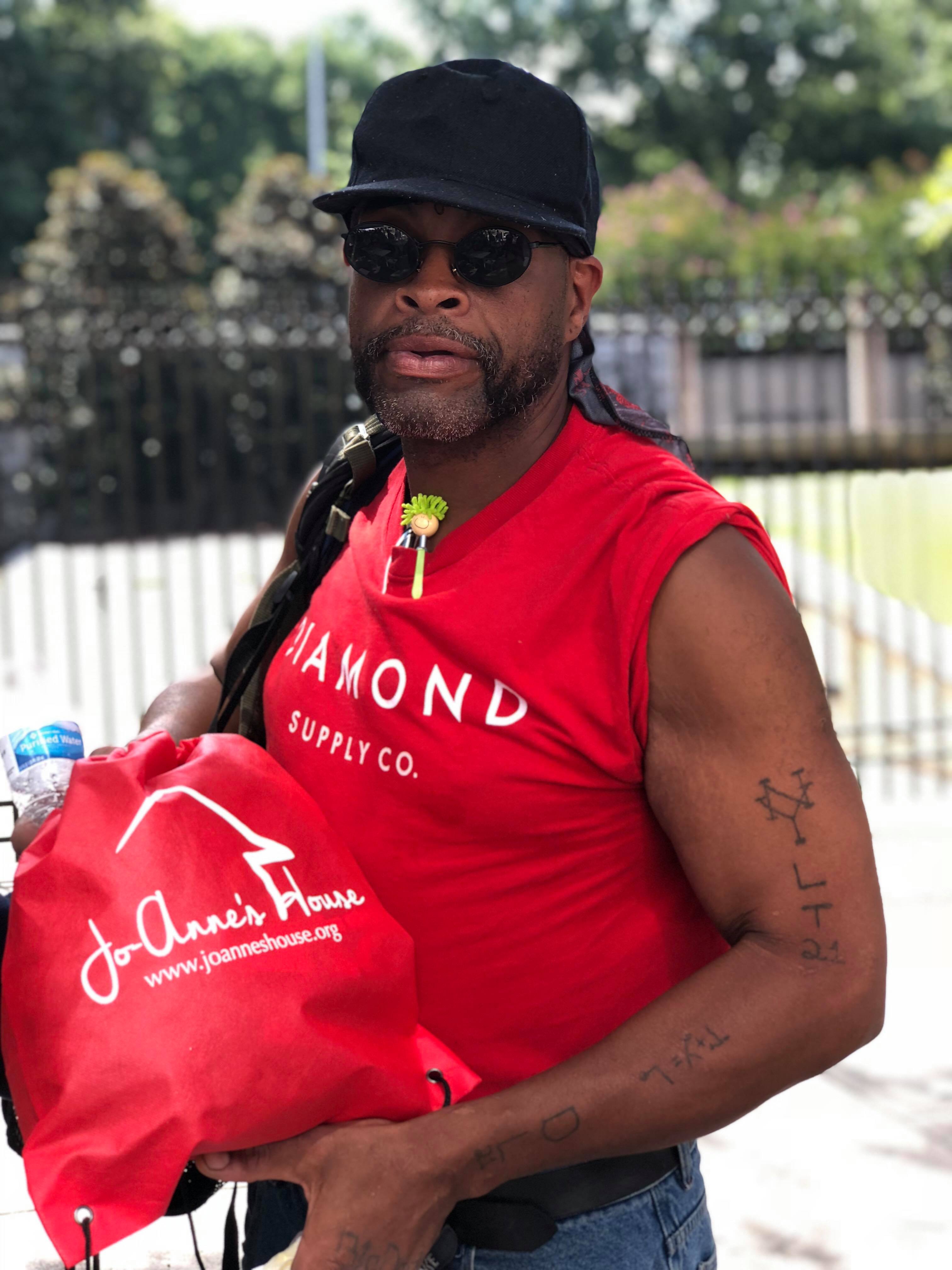 Community member with Jo-Anne's House bag