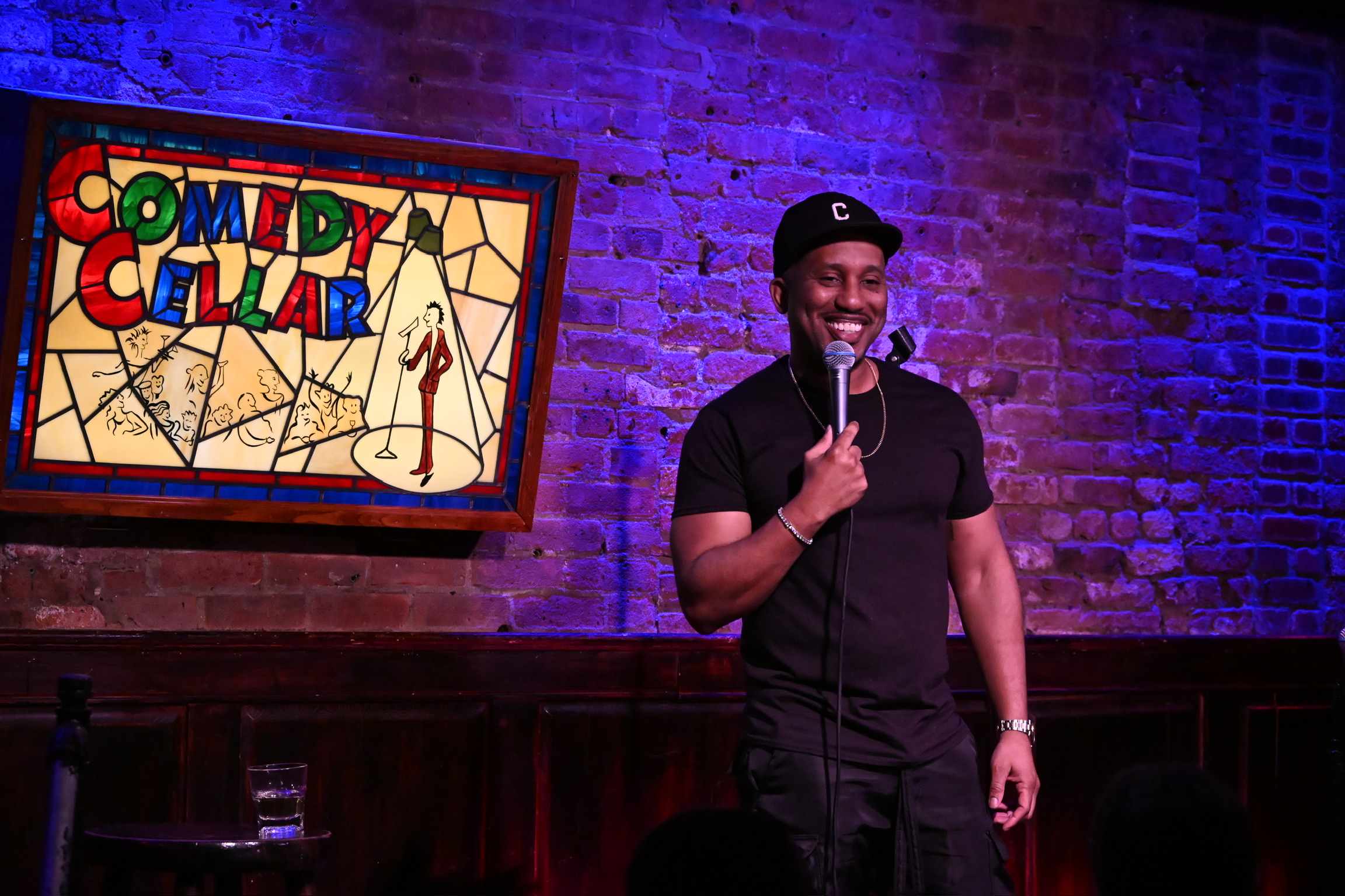 Chris Redd performing on stage at the Comedy Cellar