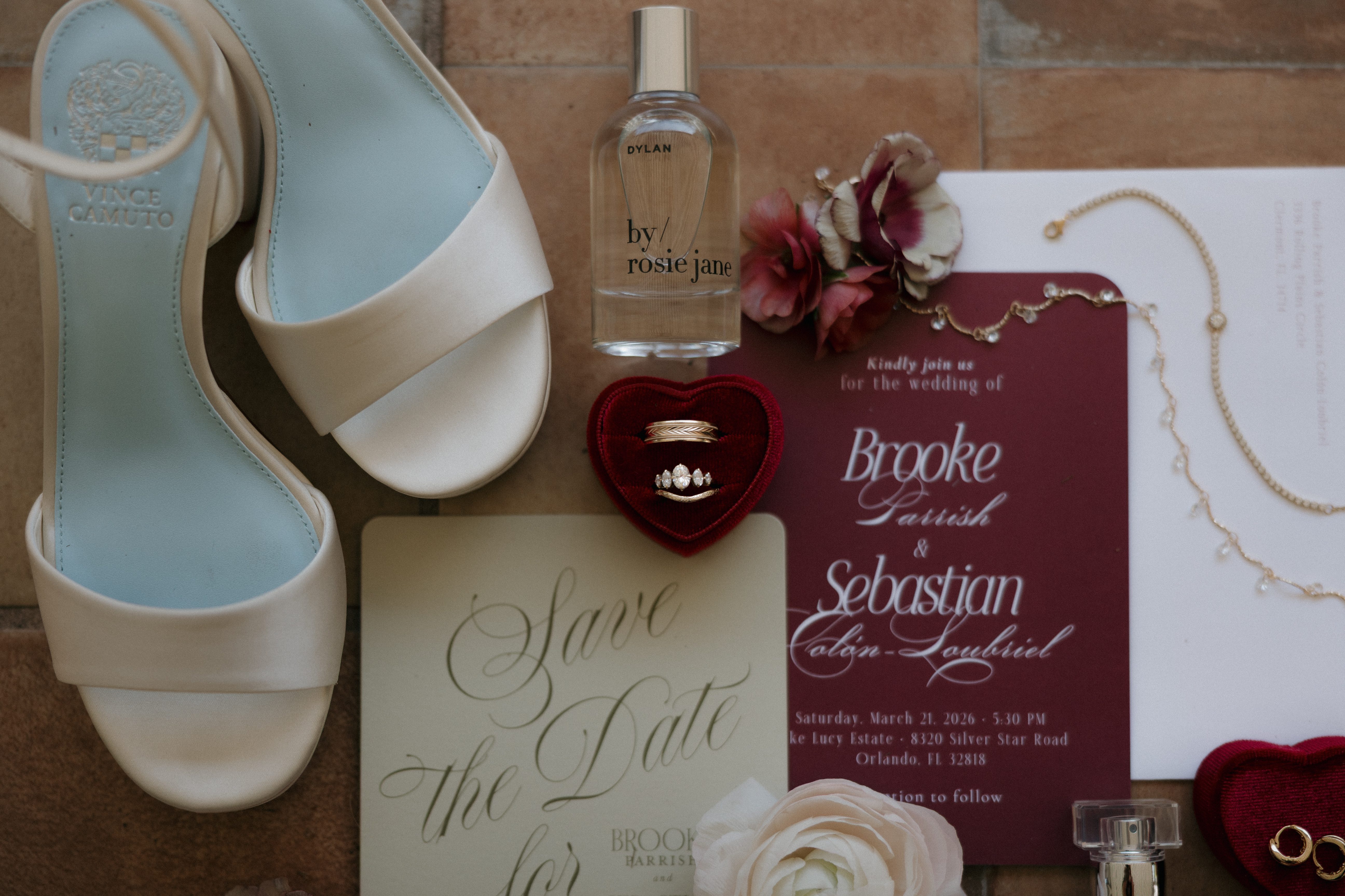Wedding stationery flat lay with rings and bridal accessories