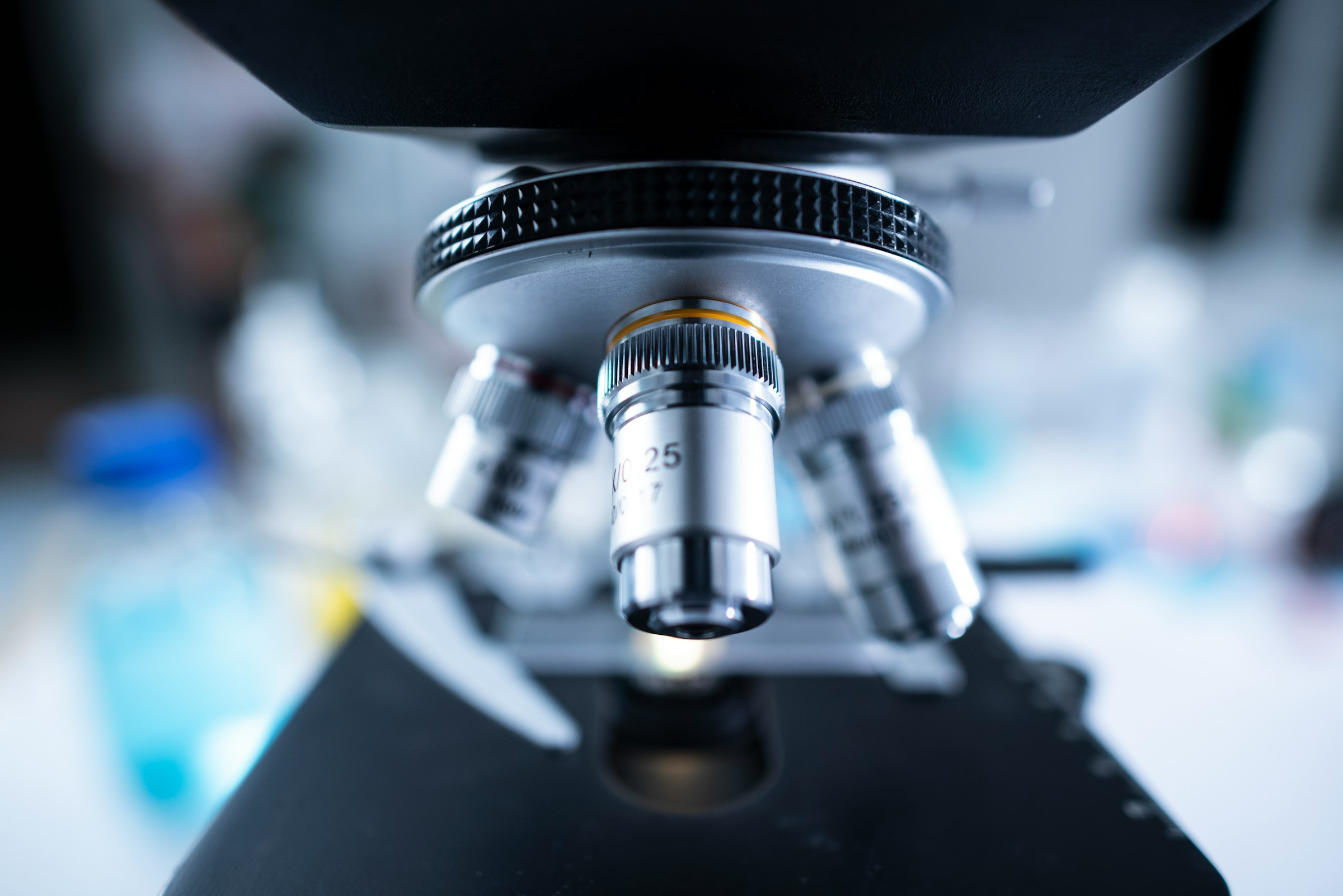 Close-up of microscope objective lenses in a laboratory setting