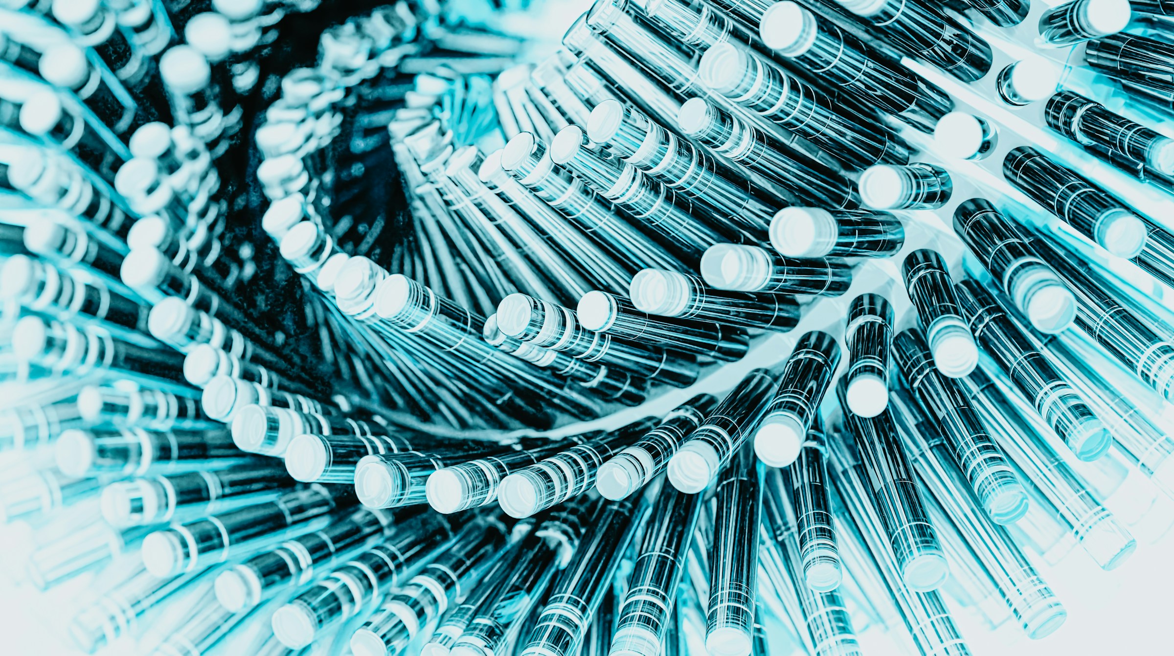 Cyan spiral vortex of glass tubes representing pharmaceutical testing