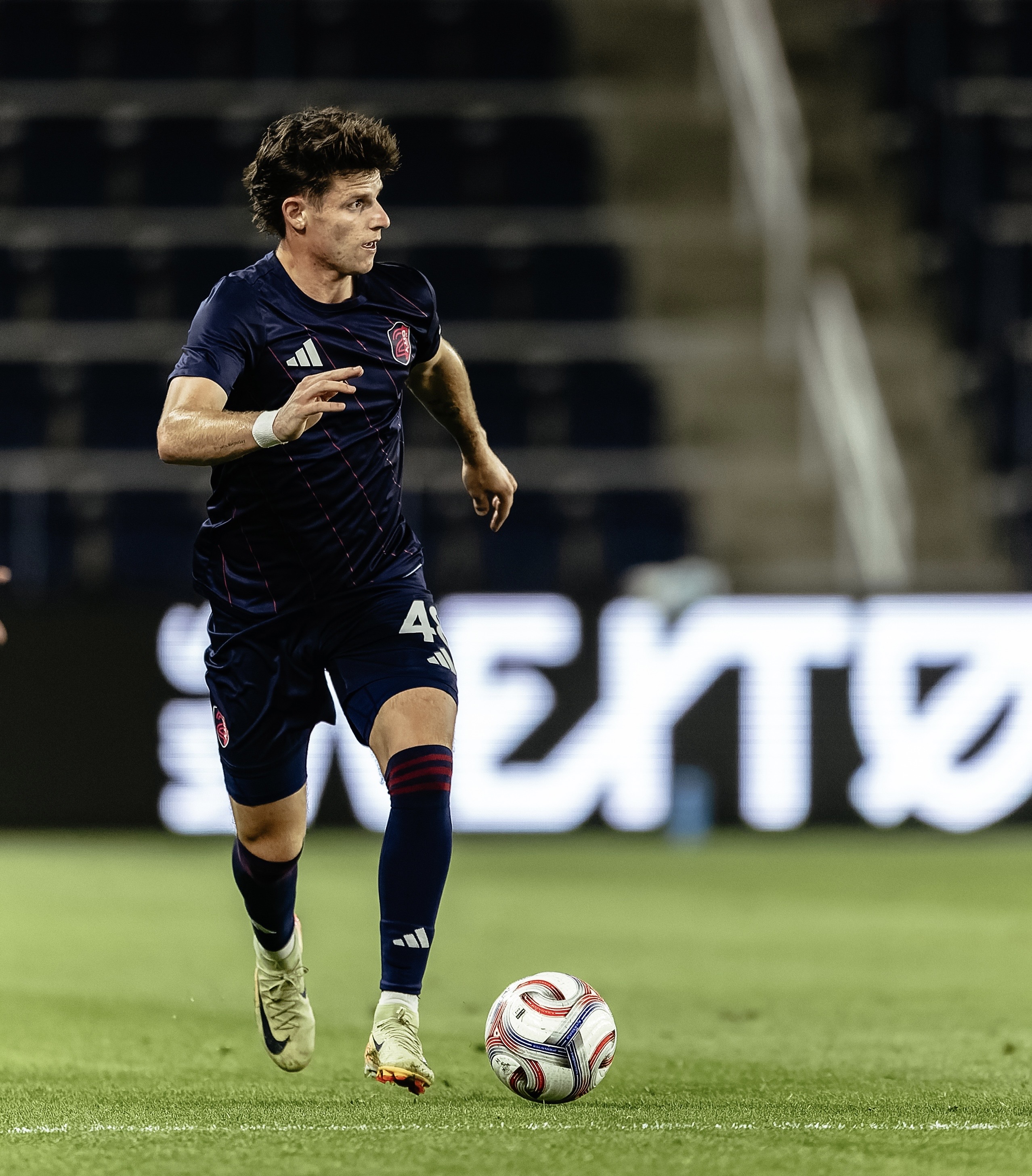 Riley Lynch playing professional soccer at night