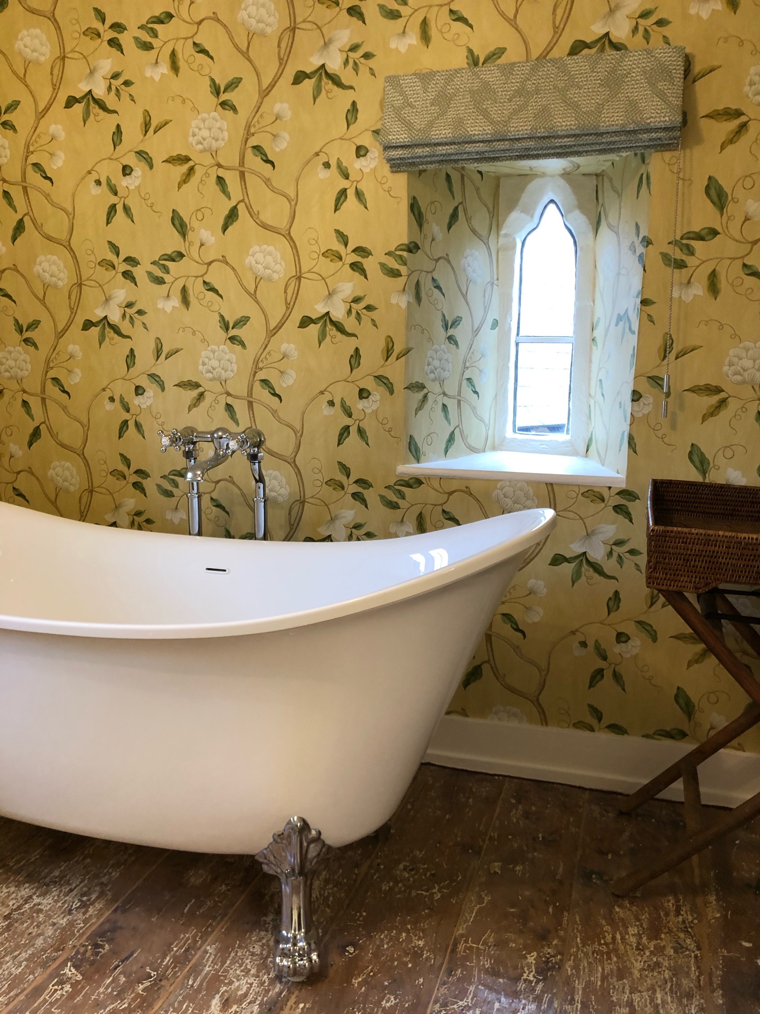 Bathroom with chinoiserie Snow Tree wallpaper and freestanding bath