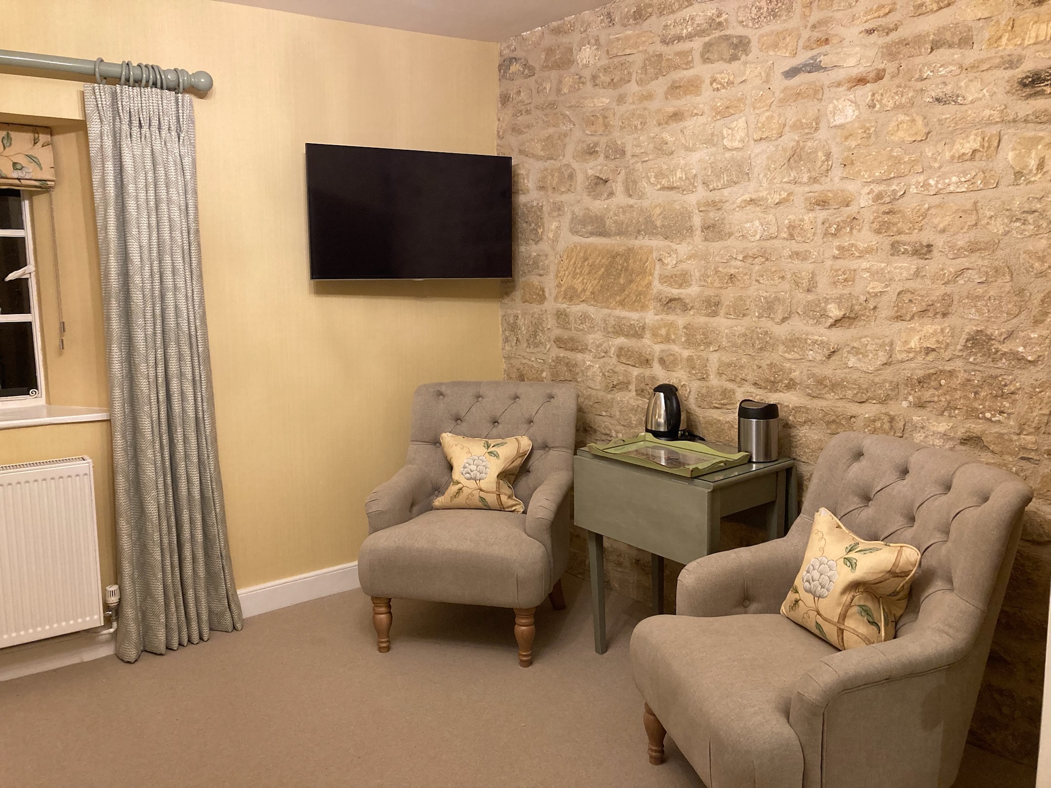 Bedroom with exposed Cotswold stone feature wall