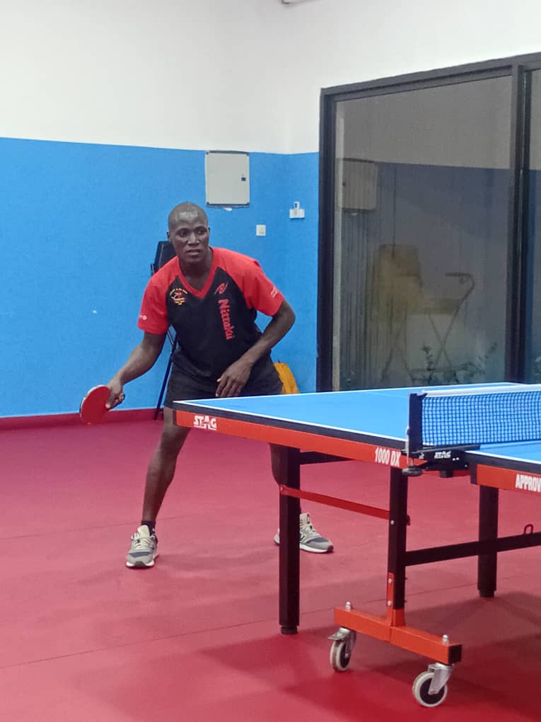 Unisa Sesay, Sierra Leone's number one table tennis player, in ready position at the table