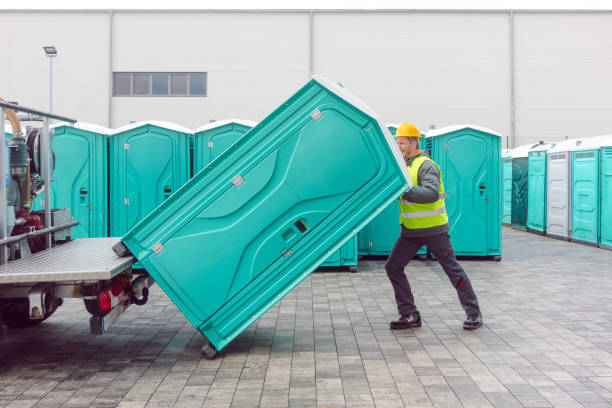 Portable restroom being loaded for delivery