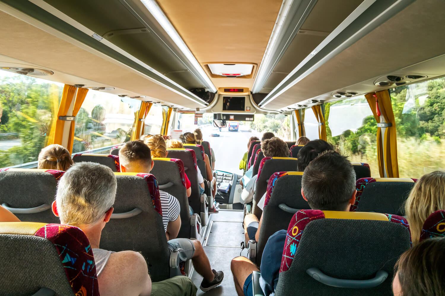 Passengers seated inside a coach on a journey