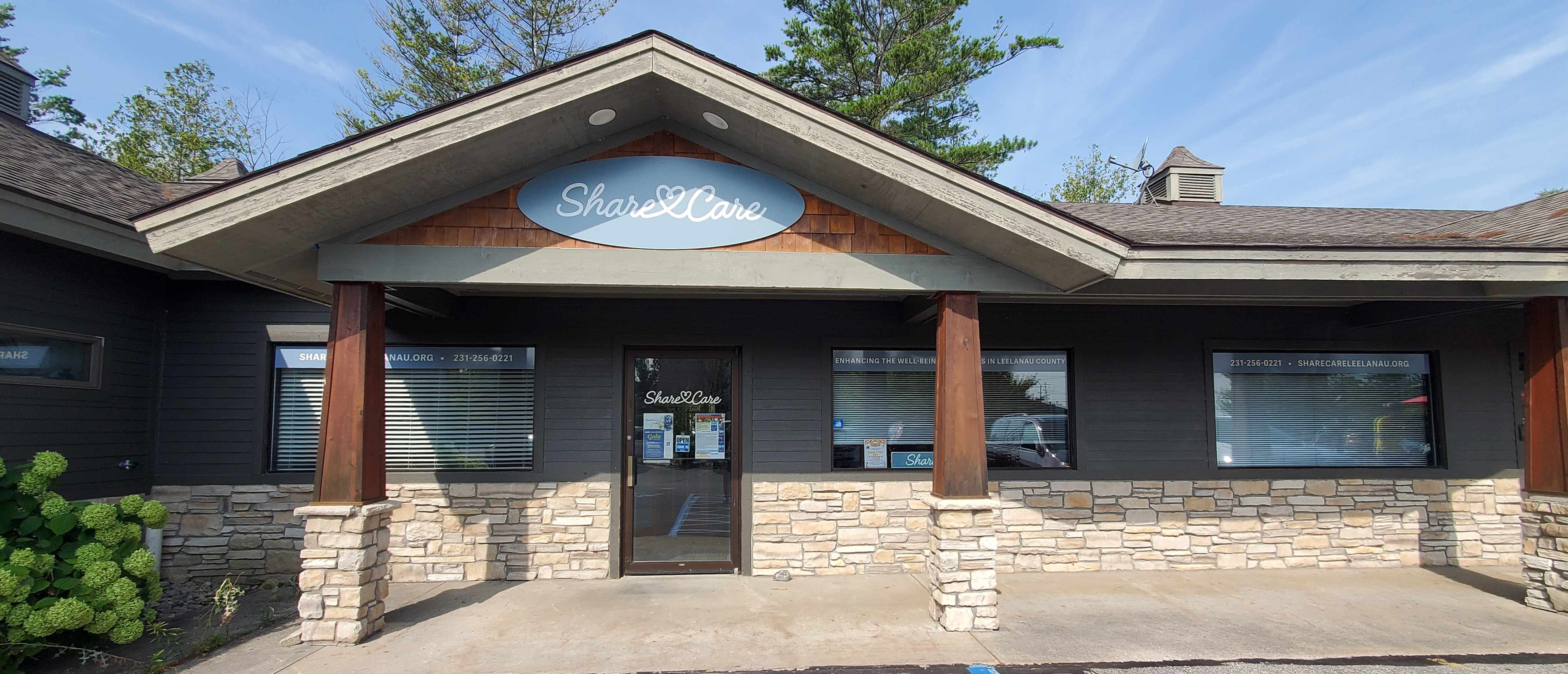 ShareCare Leelanau building exterior with stone facade and wooden pillars