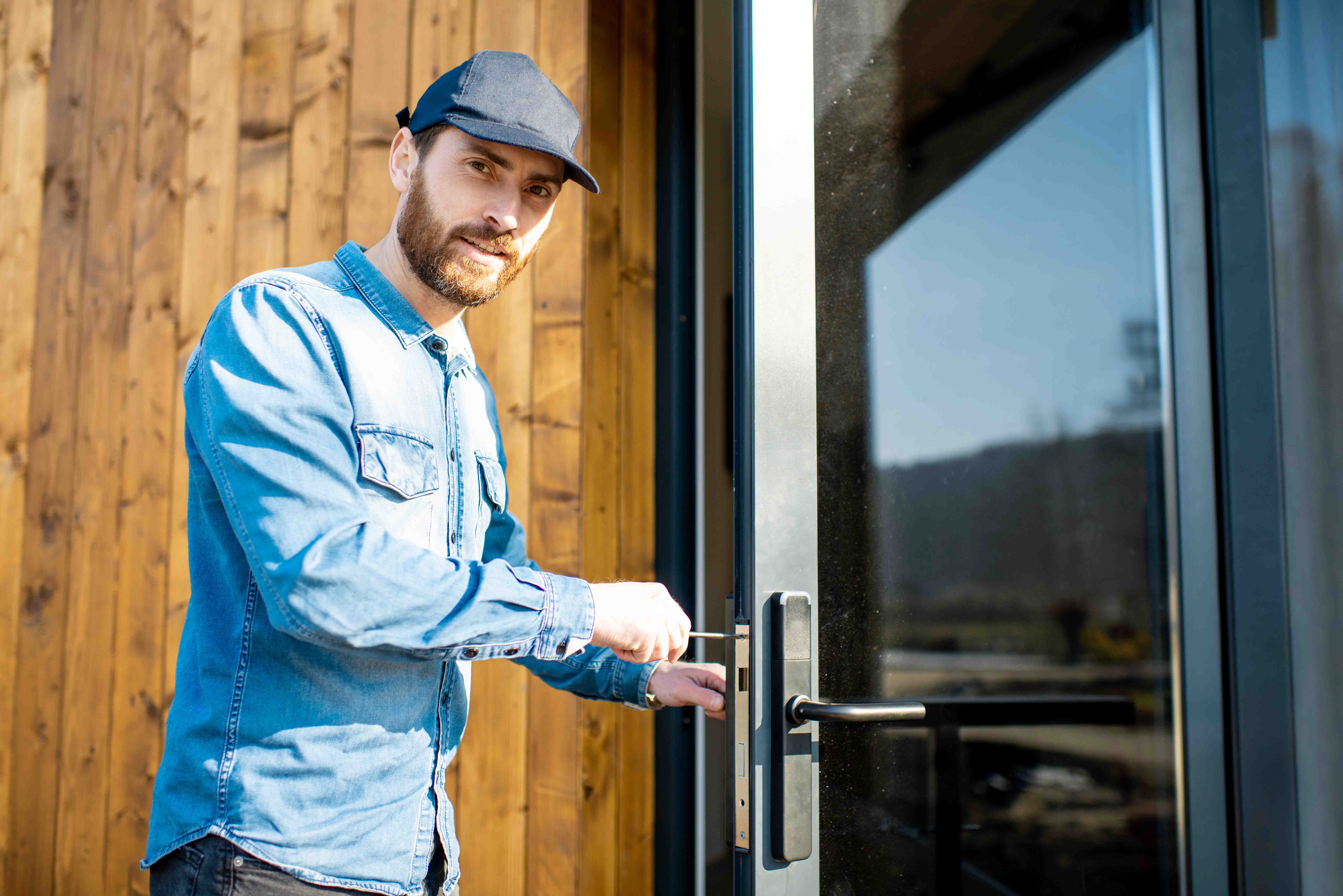 Locksmith opening a modern glass door