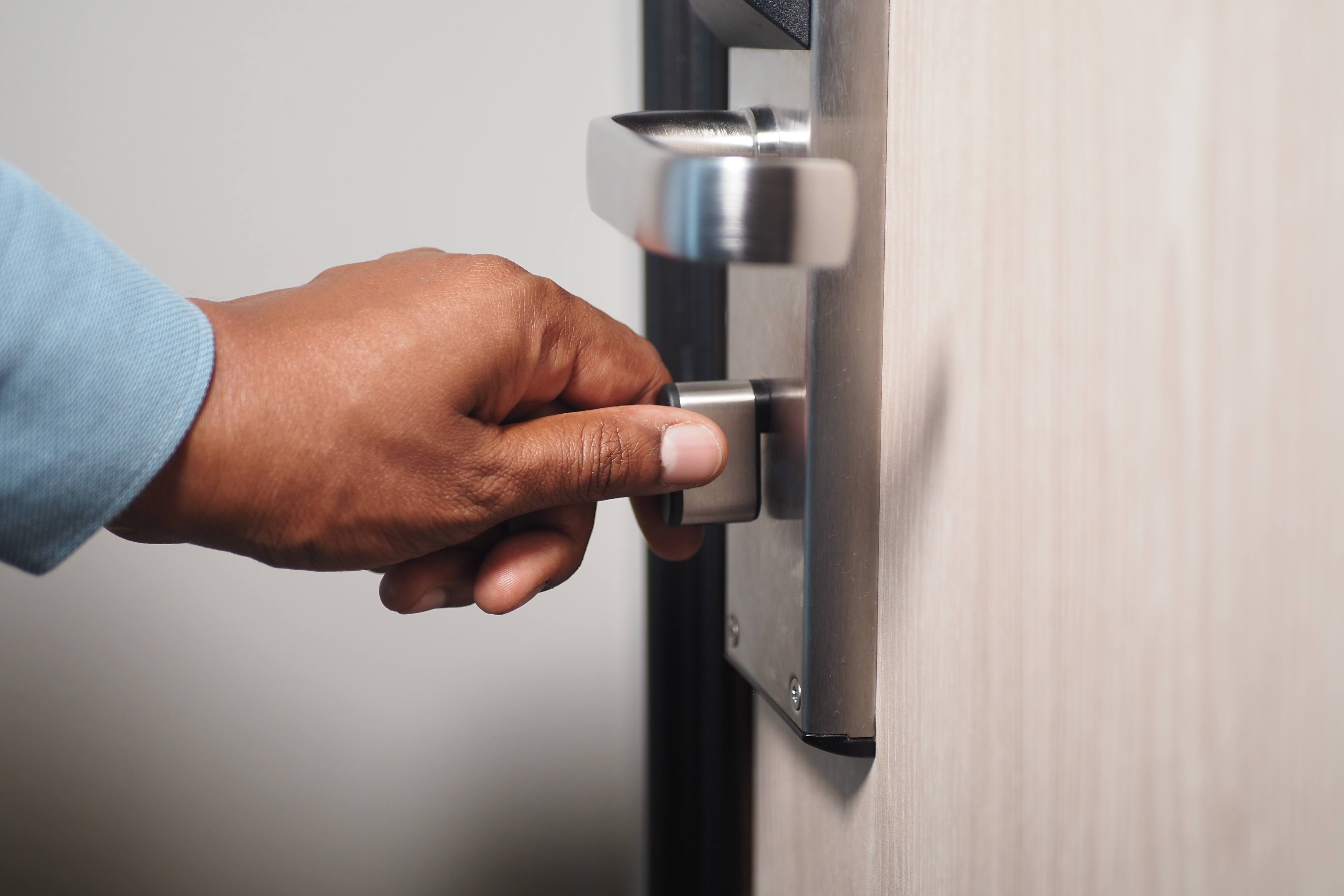 Hand operating an electronic commercial door lock