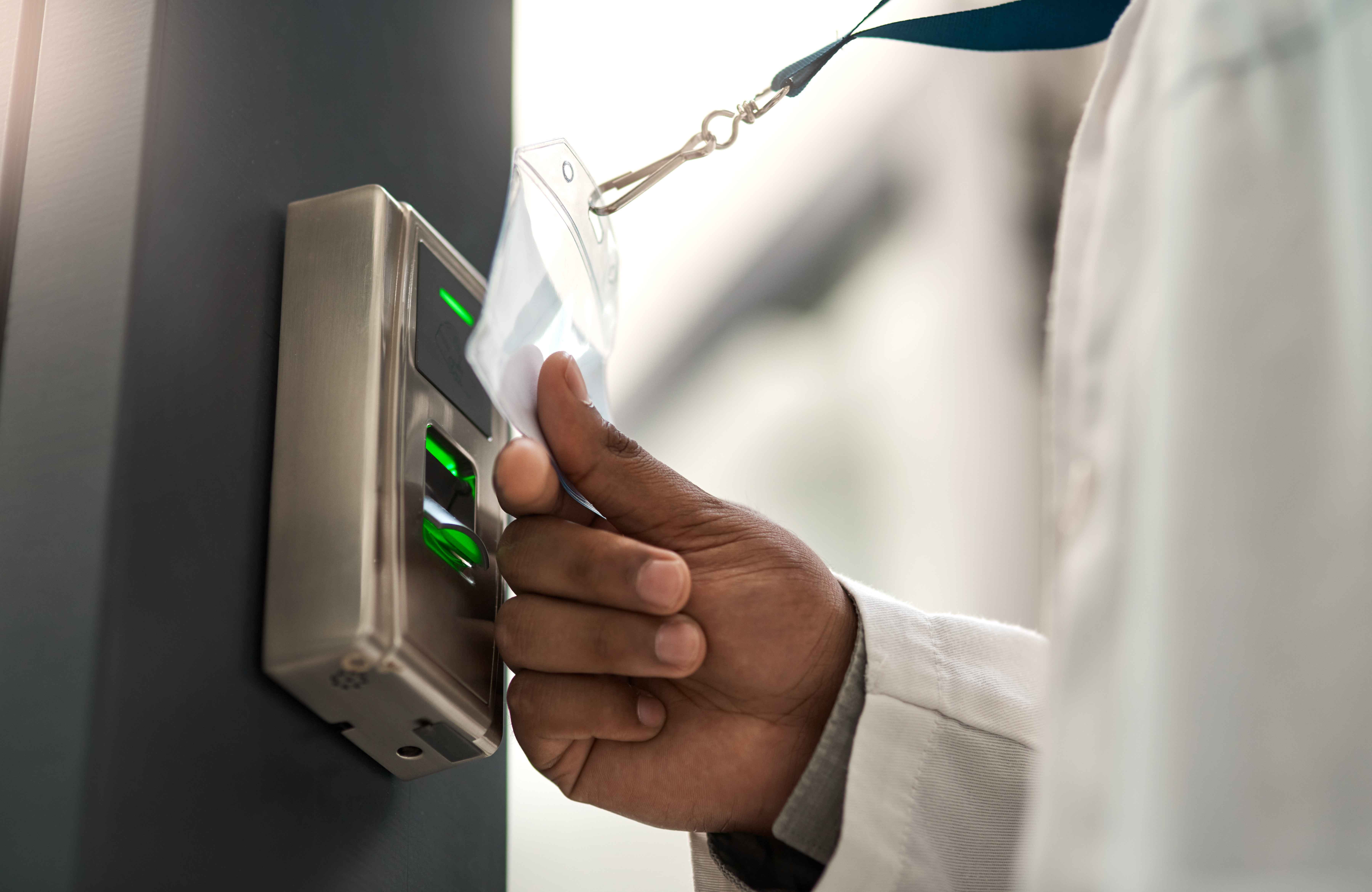 Employee using a badge reader to access a commercial door