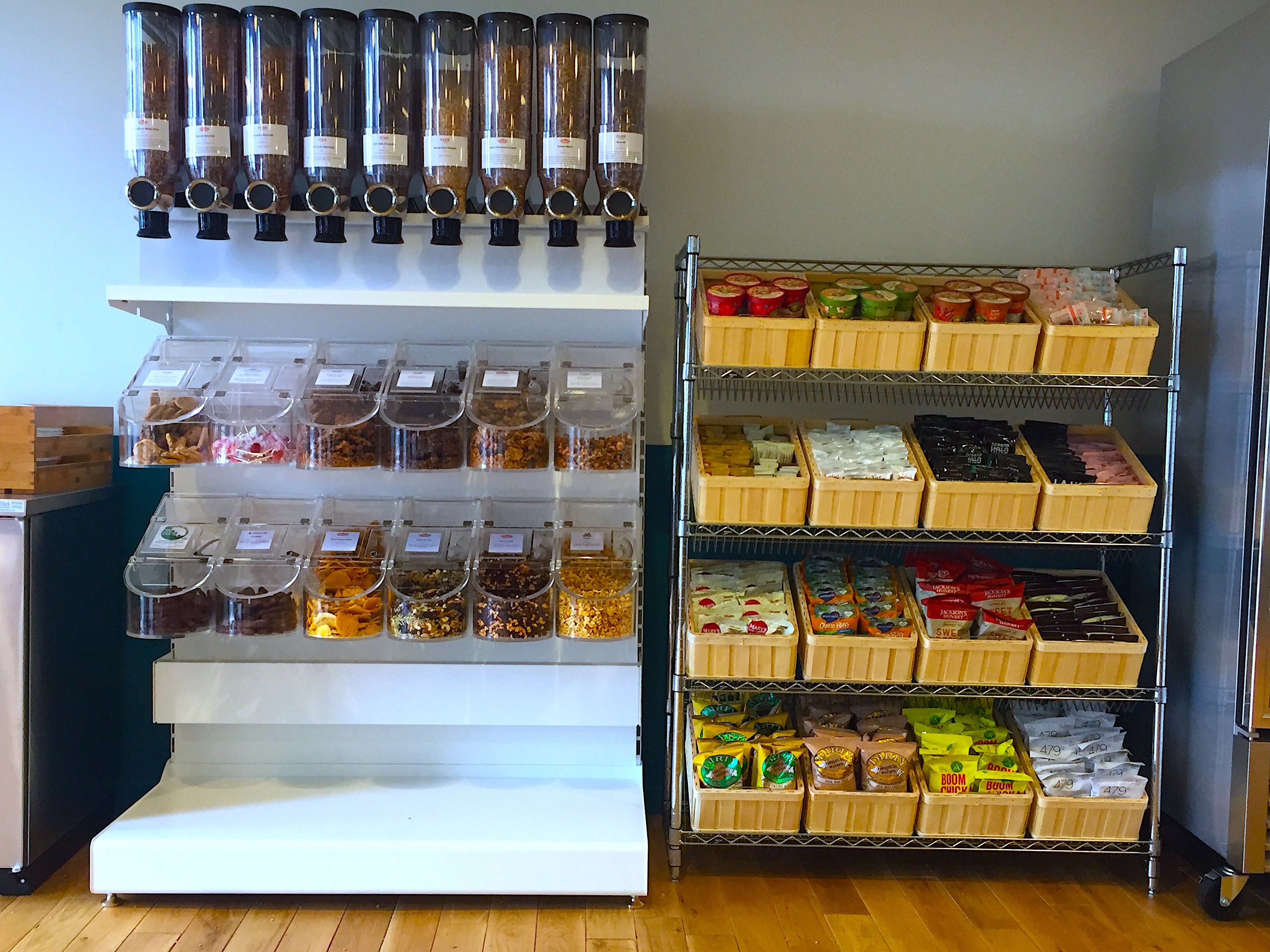 Managed micro-kitchen setup with beverage dispensers and organized snack storage