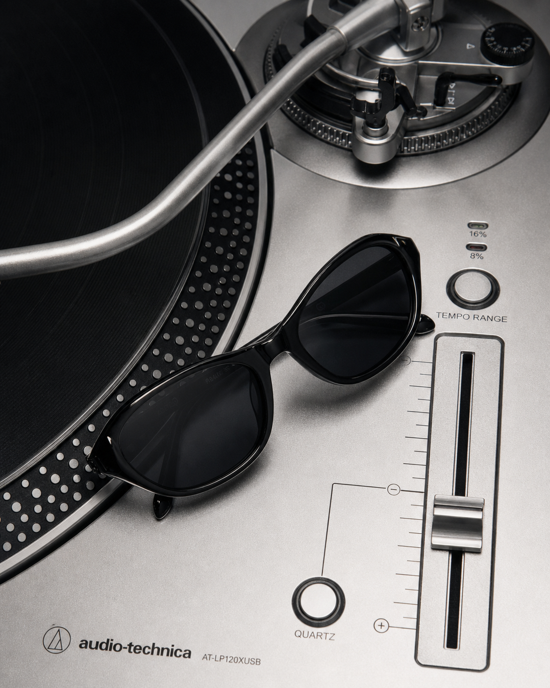 SONIQ cat-eye sunglasses on an Audio-Technica turntable