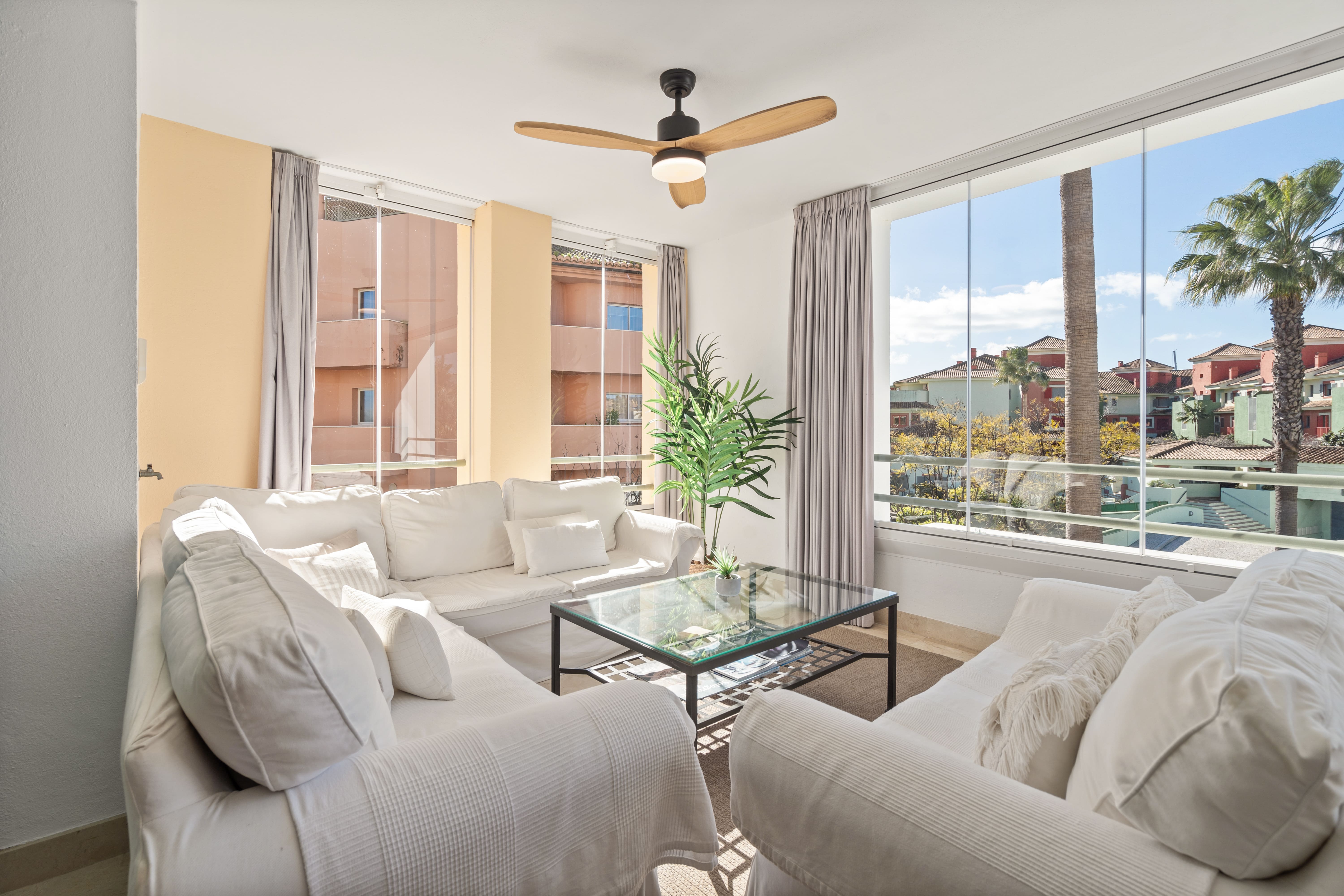 Sotogrande Alboaire - Sunlit lounge with white sofas and marina views