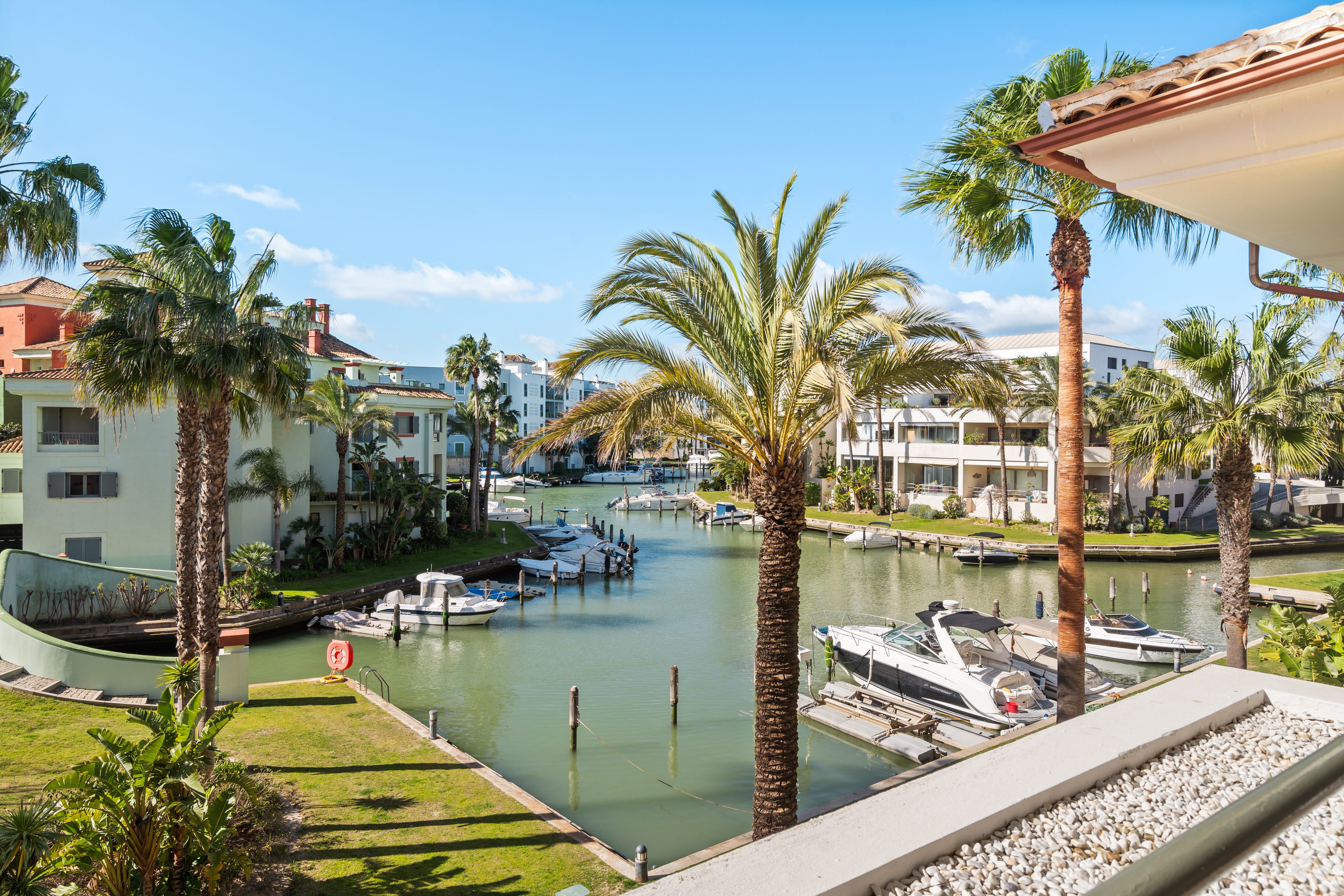 Sotogrande Alboaire - Waterway view with boats and colorful buildings