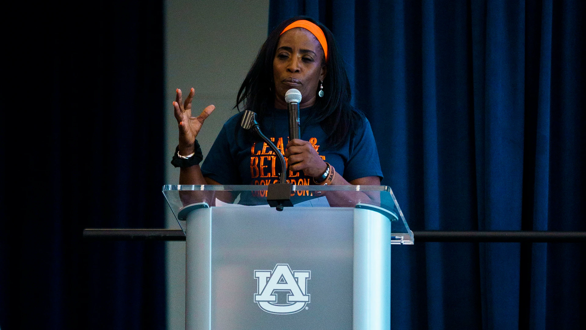 Ruthie Bolton delivering a keynote from behind a podium