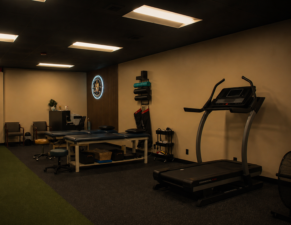 Interior of the Clark Performance Physical Therapy clinic with treatment table and training equipment