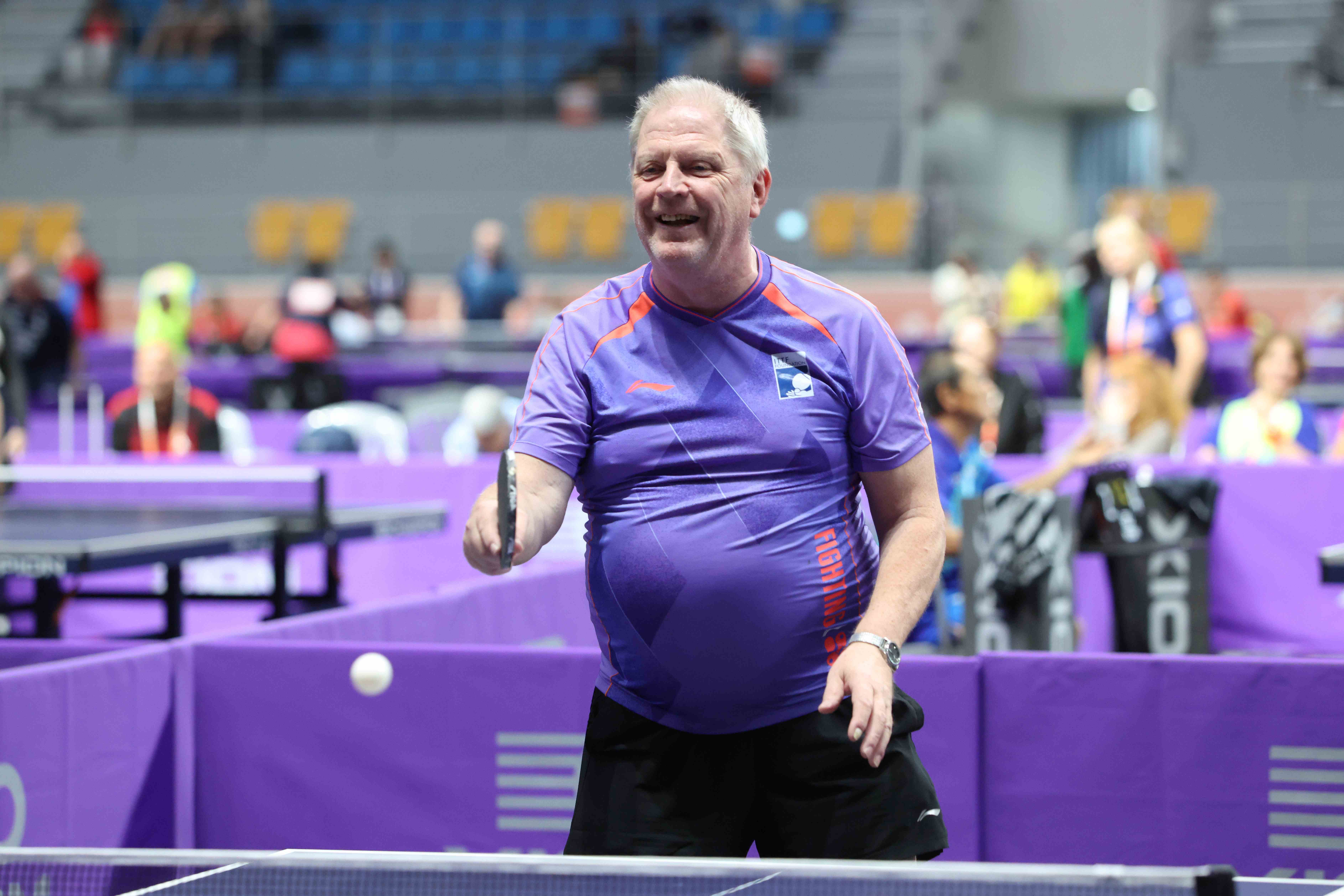 Stefan Sigfridsson smiling mid-game at the ITTF World Masters in Gangneung, holding his paddle