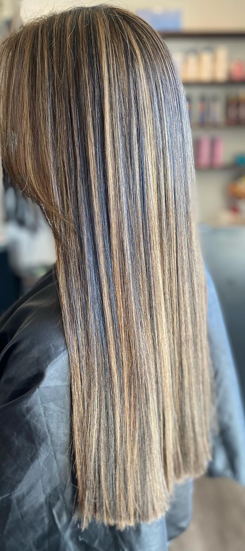 Side back view of brunette with blonde highlights, straight