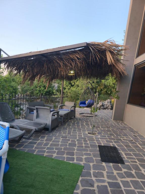 Outdoor terrace with lounge seating and thatched umbrella