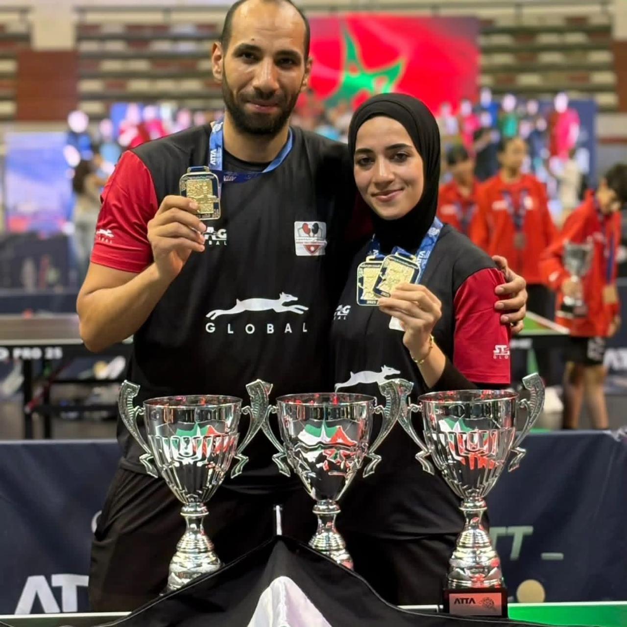 Taima Abu Yaman and her brother Zaid Abu Yaman with three trophies after a tournament in Morocco