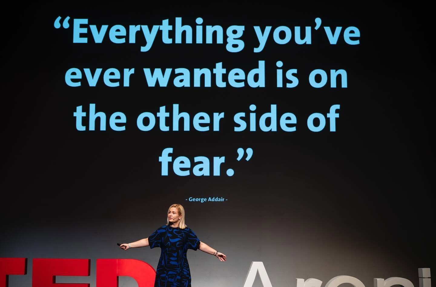 Katerina on the TEDxAreni Women stage beneath the words Everything you’ve ever wanted is on the other side of fear