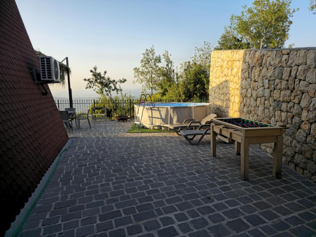 Outdoor terrace with pool, lounge chairs, and mountain views at Orion Hills