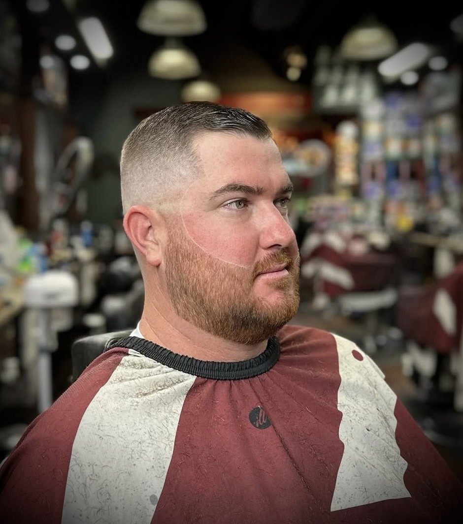 Adrian Velez's precision skin fade with full beard styling