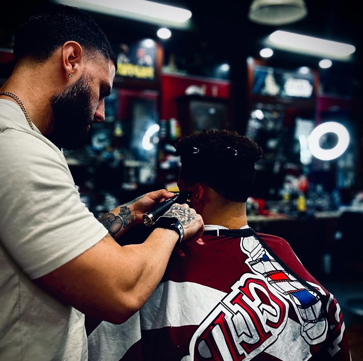 Adrian Velez working on a client in the cinema-themed barbershop