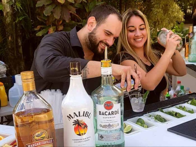 Professional bartenders mixing premium cocktails - mobile mixologist South Florida