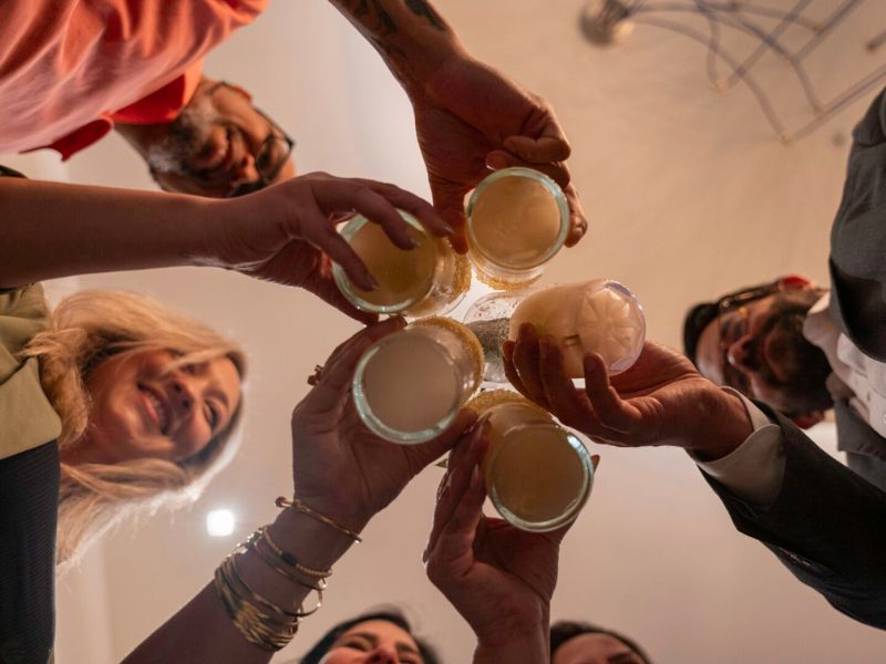 Friends celebrating with drinks overhead shot - party bartending service South Florida