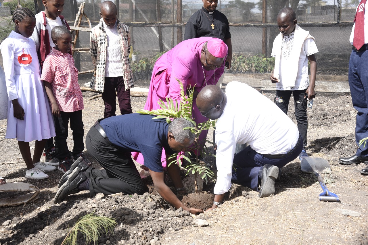Bishop and community members participating in a tree planting activity