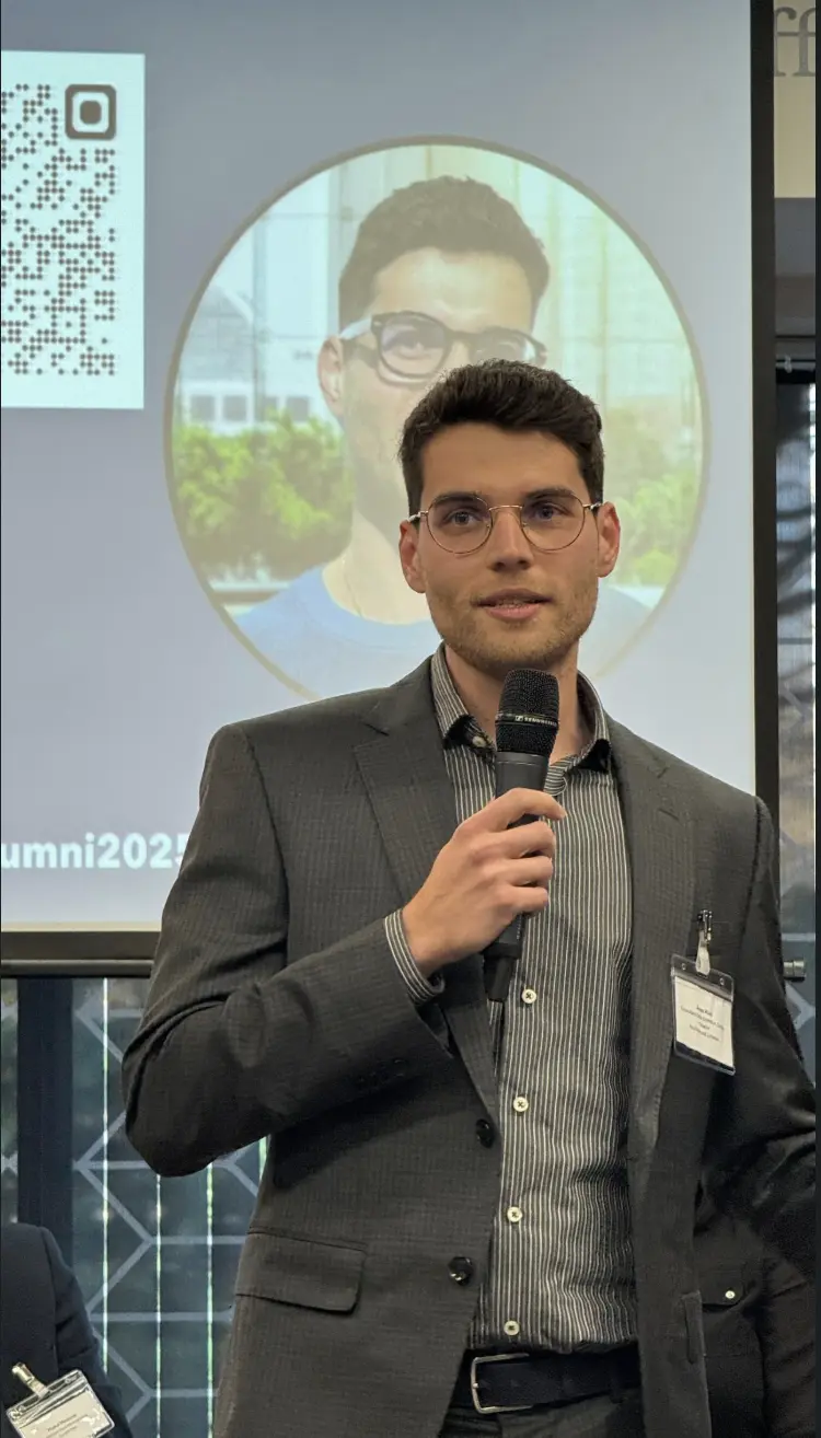 Anas Riad presenting at a university alumni event