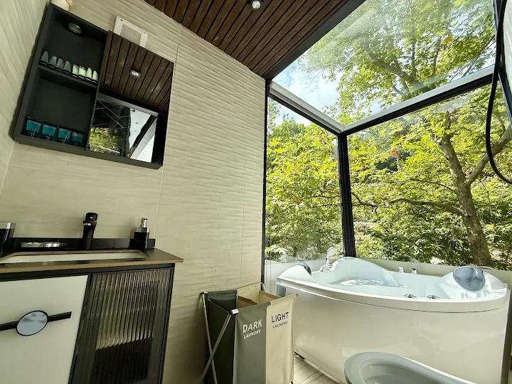 Bathroom with jacuzzi and forest view