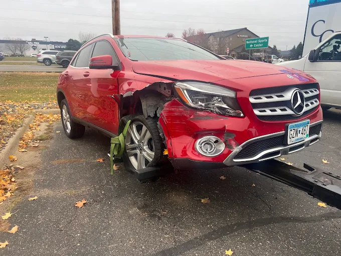 Damaged red SUV ready for roadside recovery