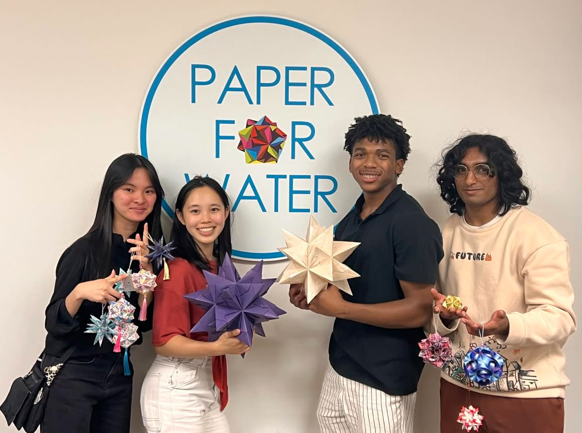 Diverse group of young volunteers with large origami stars