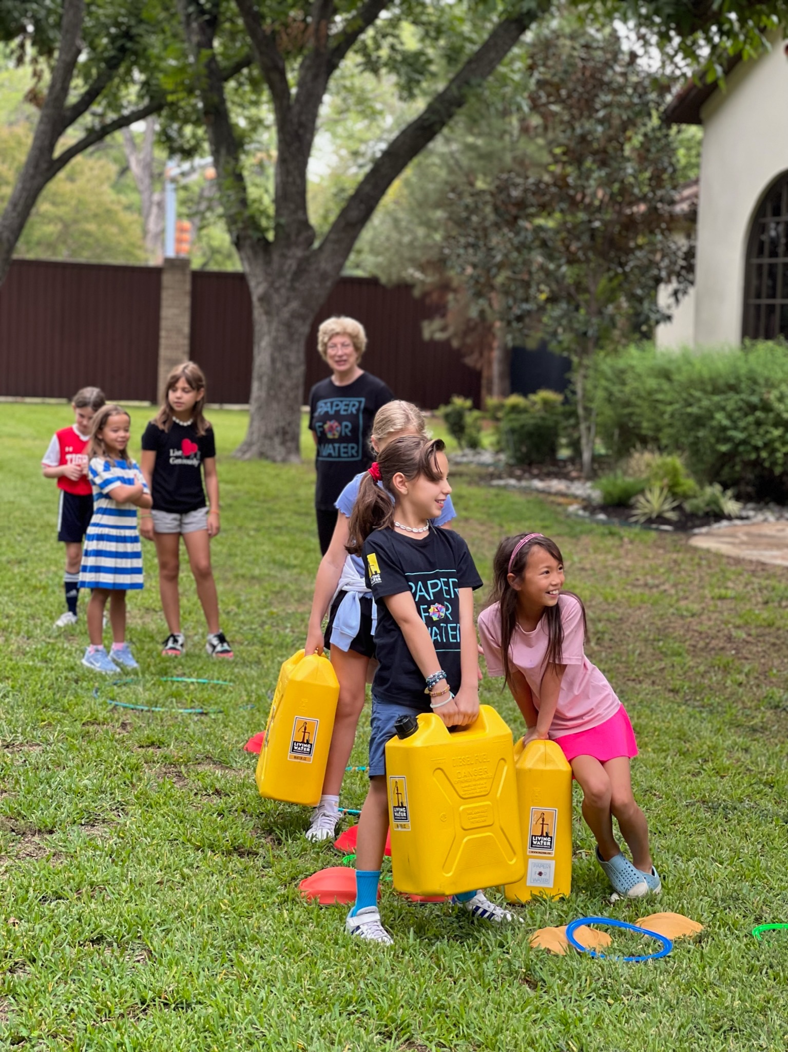 Young volunteers with yellow water containers at community event