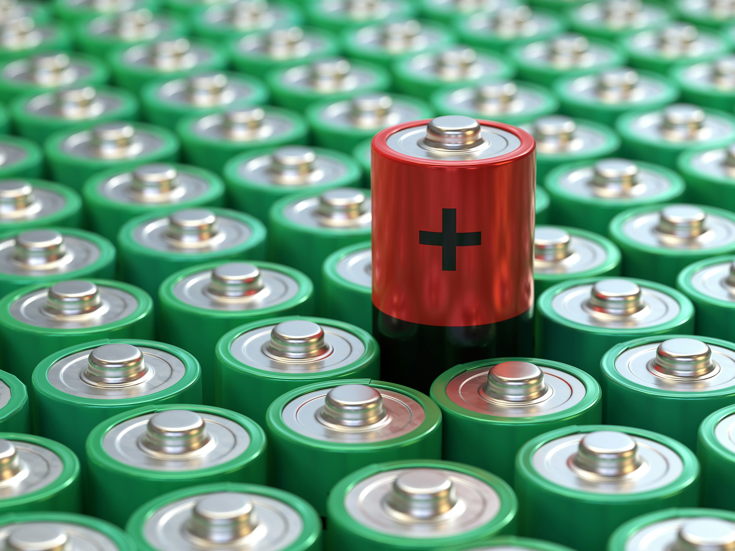 Array of green batteries with one red battery standing out representing energy storage