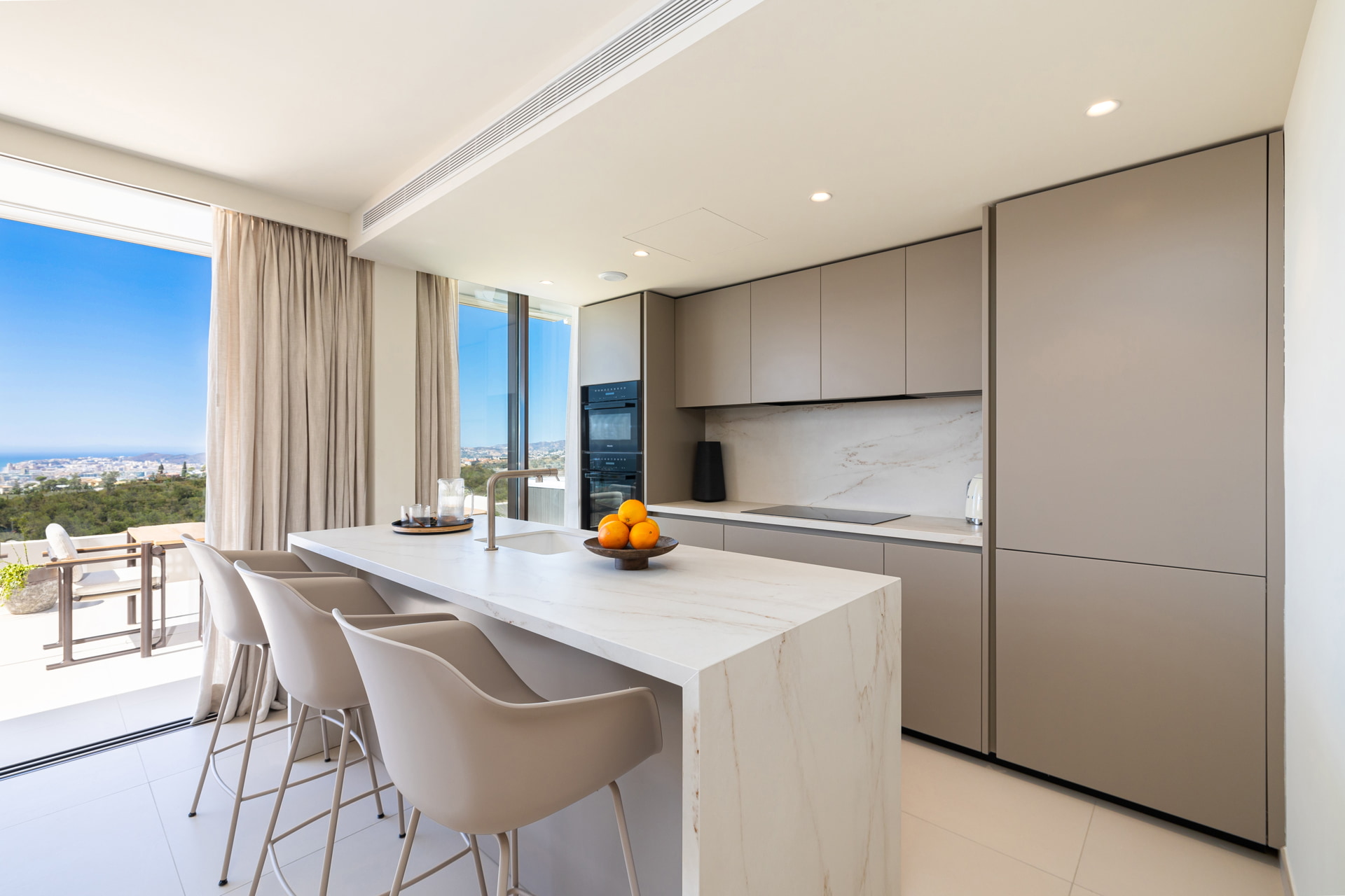 Modern luxury kitchen with marble island and panoramic views