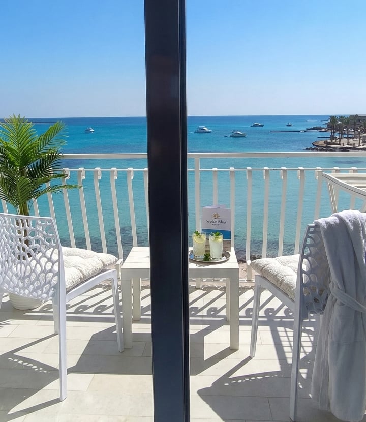 Beachfront terrace view with turquoise sea at Hotel Paradise Porto Cesareo