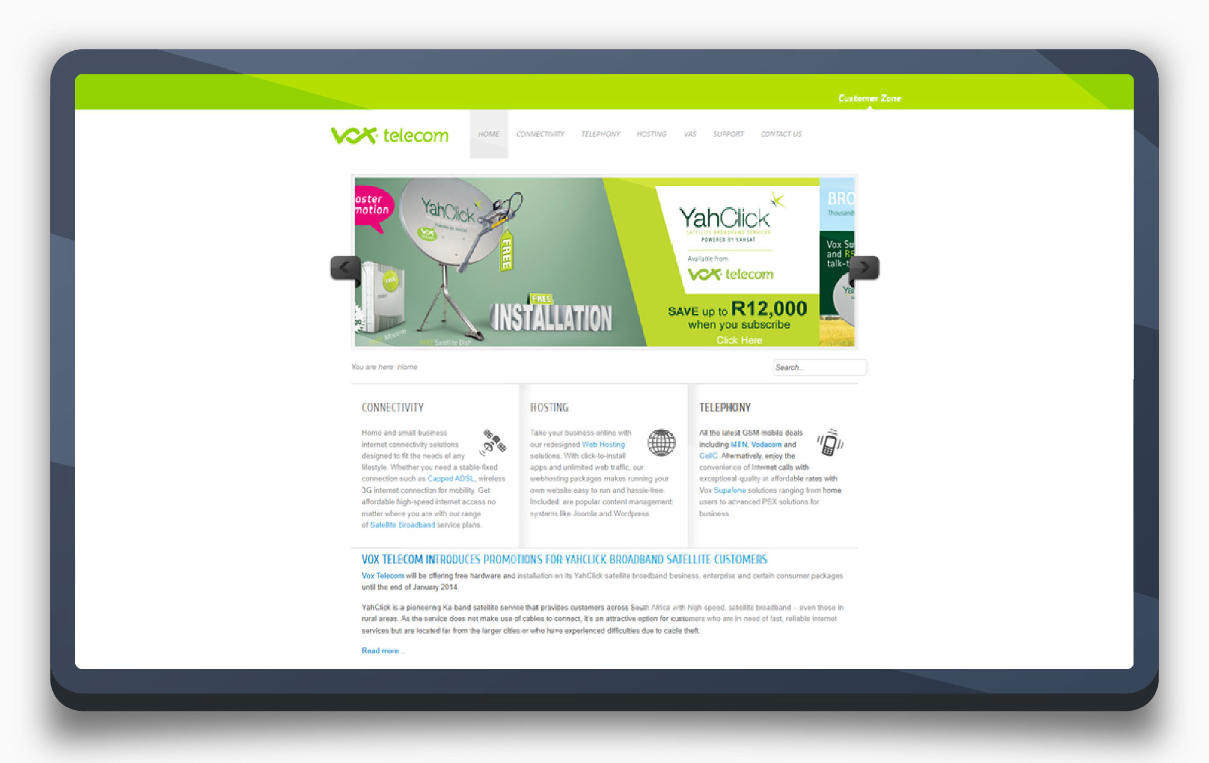 The legacy Vox Telecom homepage on a tablet, showing a cluttered layout with a YahClick satellite broadband banner ad and dense three-column text blocks