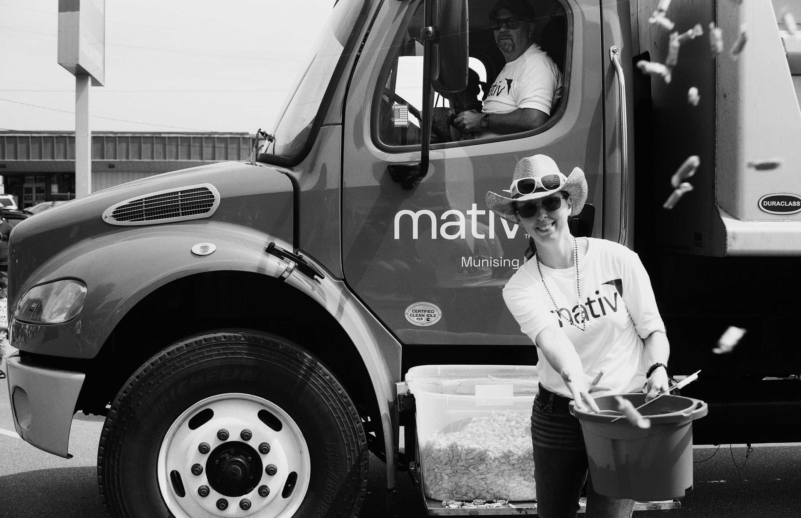 Woman with Mativ Munising Michigan truck wearing white sunglasses and white hat