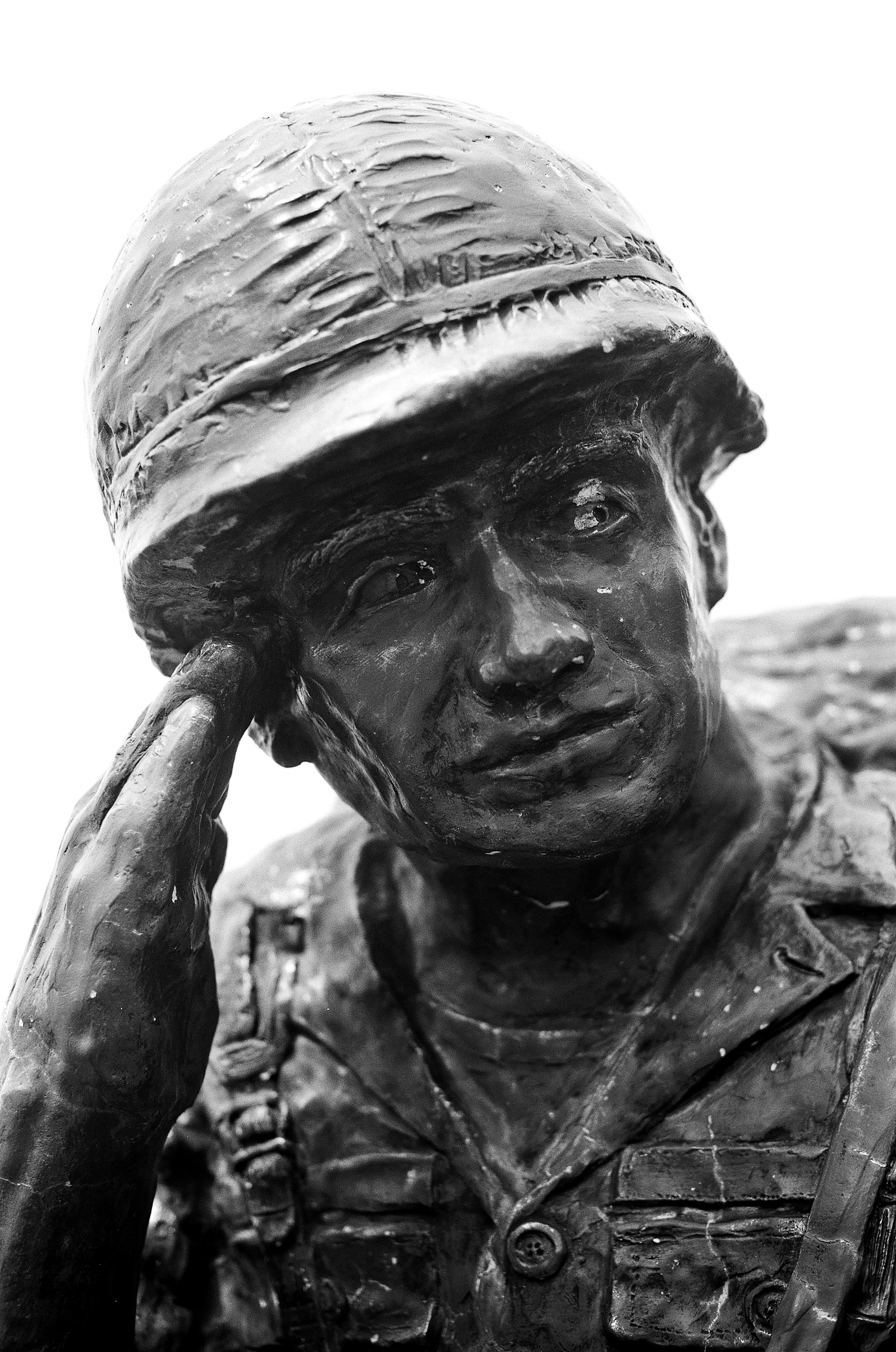 Statue sculpture of miner with headlamp and contemplative expression